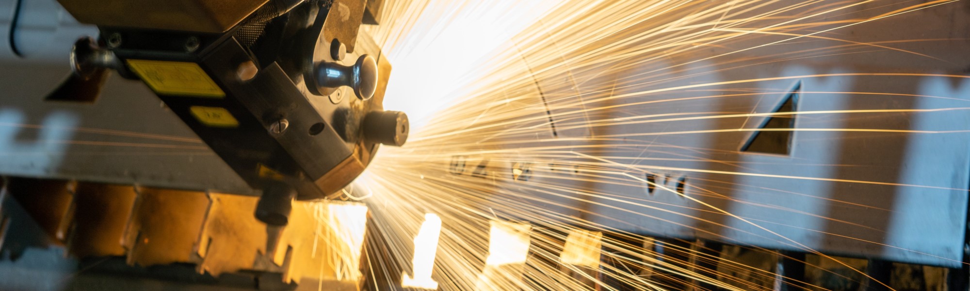 IMCO manufacturing software close up of a laser cutting a pice of metal in a metal fabrication factory