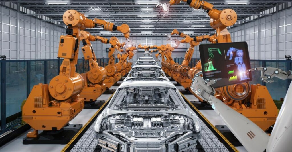 image of robotic arms on an assembly line with a human arm holding a tablet