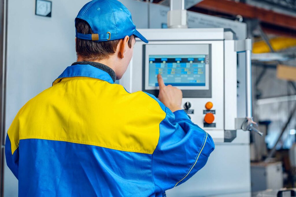 Worker in a plant checking inventory supply chain agility on the OptiPoint inventory management software module